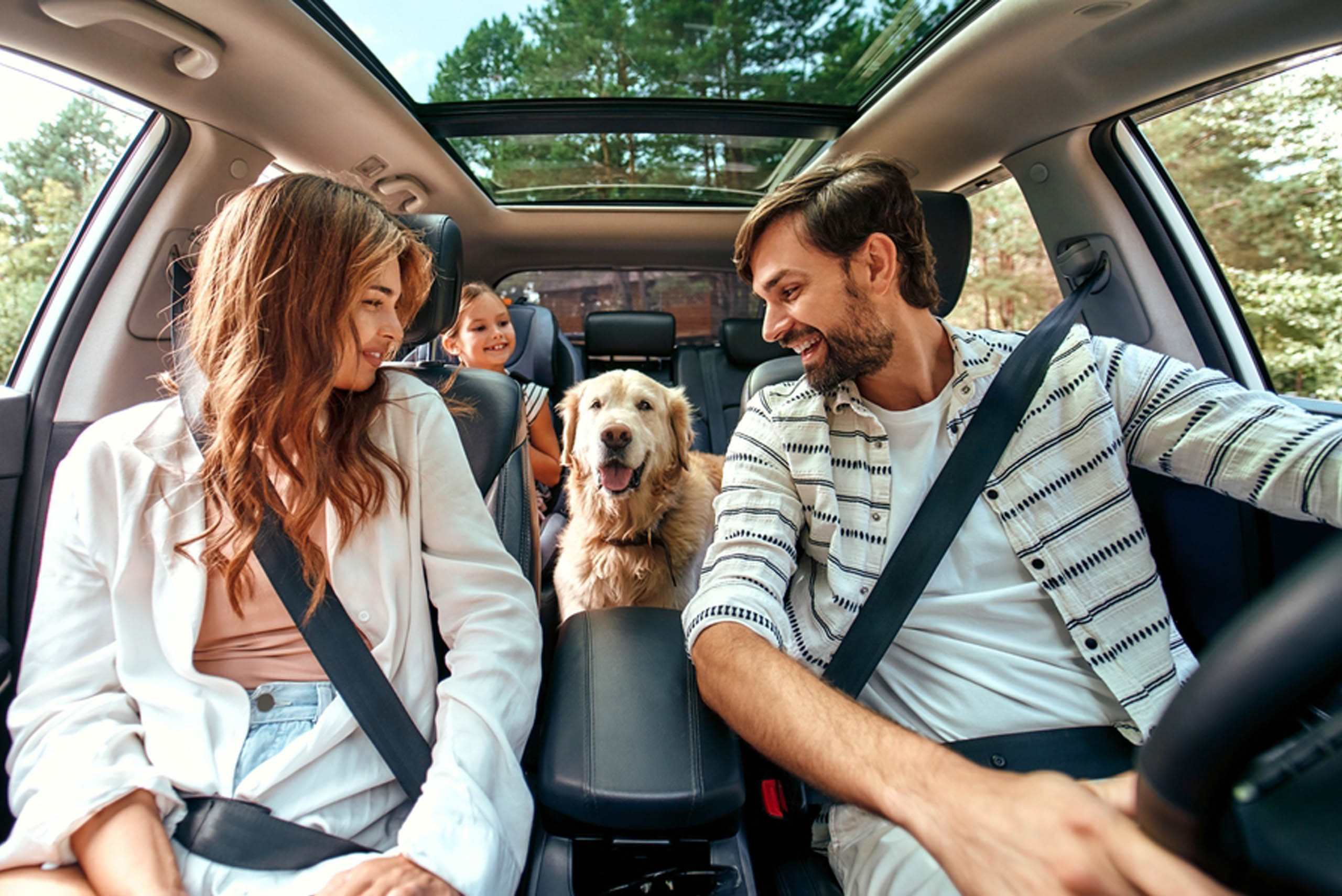 family inside a car with a man driving -  https://www.rf-ins.com/